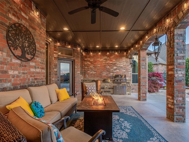 view of patio featuring a ceiling fan and an outdoor living space with a fire pit