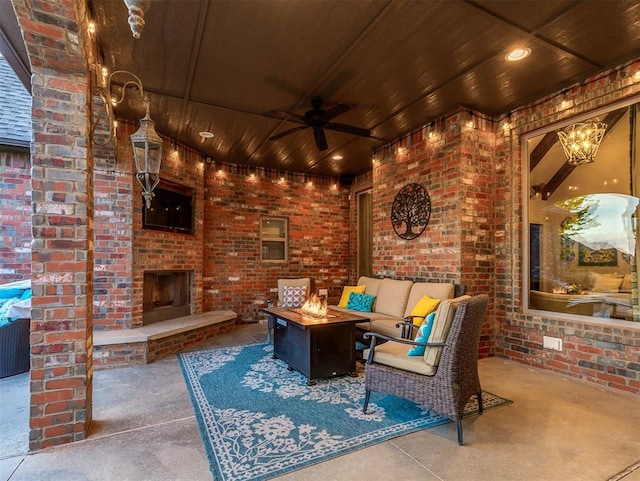 view of patio featuring ceiling fan and an outdoor living space with a fireplace