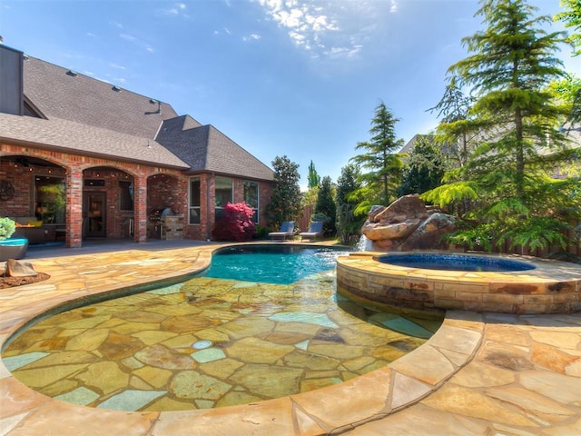 view of pool featuring a patio area and a pool with connected hot tub