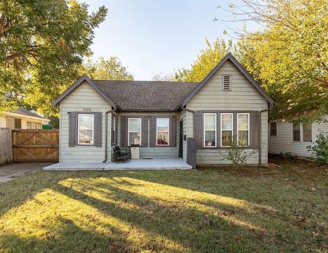 1428 NW 45th St, Oklahoma City, OK 73118 - back of property with a gate, fence, a shingled roof, a yard, and a patio area
