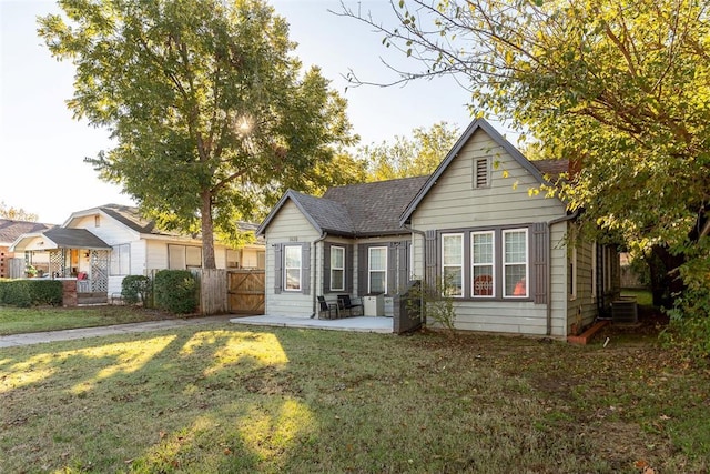 1428 NW 45th St, Oklahoma City, OK 73118 - rear view of house featuring a gate, a lawn, fence, a patio, and cooling unit
