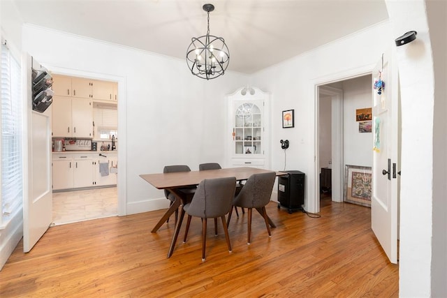 1428 NW 45th St, Oklahoma City, OK 73118 - dining room featuring a chandelier, light wood-type flooring, and ornamental molding