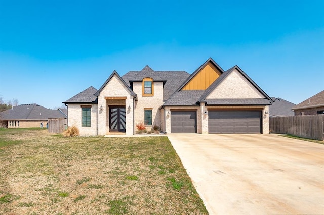 1219 N Adair Ct, Stillwater, OK 74075 - view of front of home featuring concrete driveway, board and batten siding, a front lawn, an attached garage, and fence