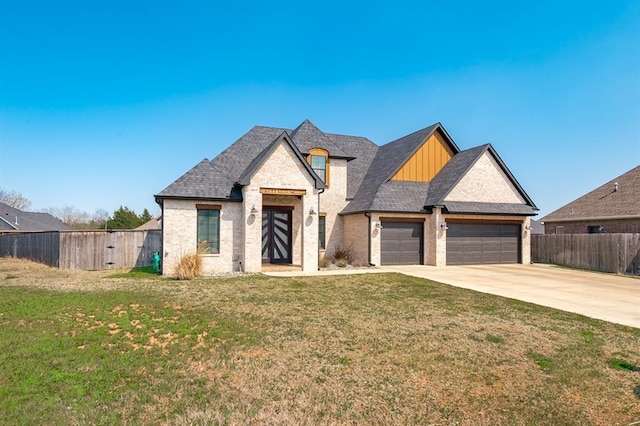 1219 N Adair Ct, Stillwater, OK 74075 - view of front facade featuring board and batten siding, a garage, a front yard, fence, and concrete driveway