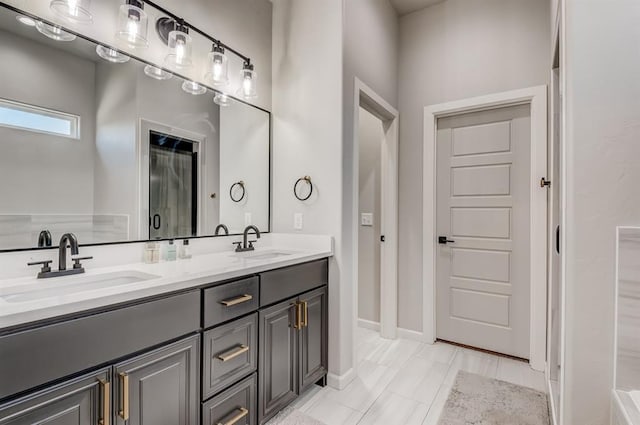 1219 N Adair Ct, Stillwater, OK 74075 - bathroom with double vanity, a sink, and baseboards