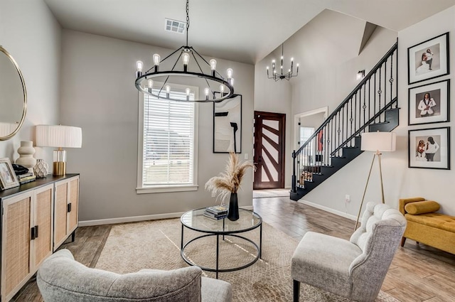 1219 N Adair Ct, Stillwater, OK 74075 - living room featuring visible vents, baseboards, a notable chandelier, and wood finished floors