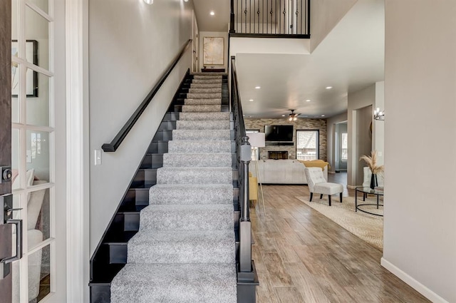 1219 N Adair Ct, Stillwater, OK 74075 - stairway with recessed lighting, baseboards, a ceiling fan, and wood finished floors