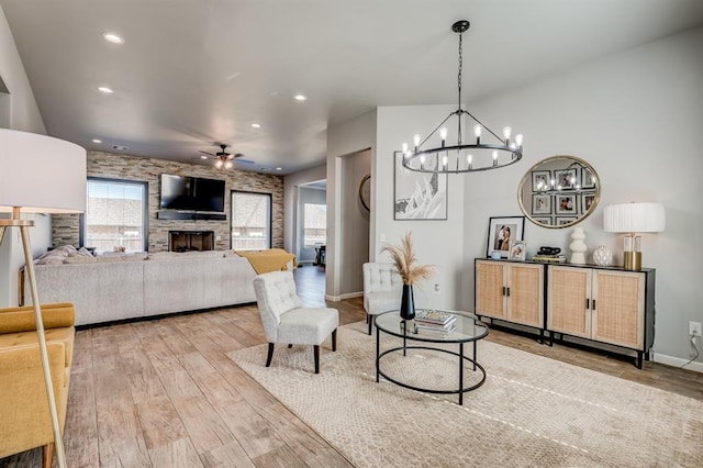 1219 N Adair Ct, Stillwater, OK 74075 - living room featuring light wood-style flooring, ceiling fan with notable chandelier, recessed lighting, and a wealth of natural light