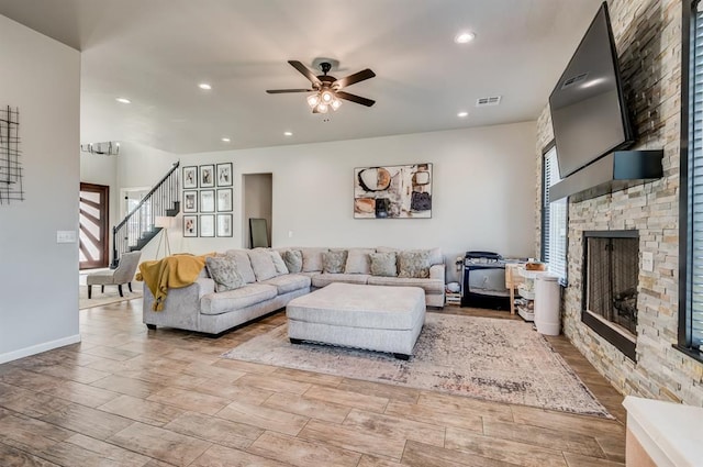 1219 N Adair Ct, Stillwater, OK 74075 - living area with a healthy amount of sunlight, a stone fireplace, visible vents, and stairs