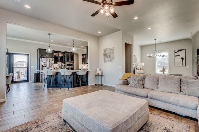 1219 N Adair Ct, Stillwater, OK 74075 - living room with recessed lighting, light wood-style floors, ceiling fan with notable chandelier, and baseboards