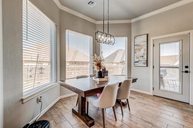 1219 N Adair Ct, Stillwater, OK 74075 - dining room with ornamental molding, wood finish floors, an inviting chandelier, and baseboards