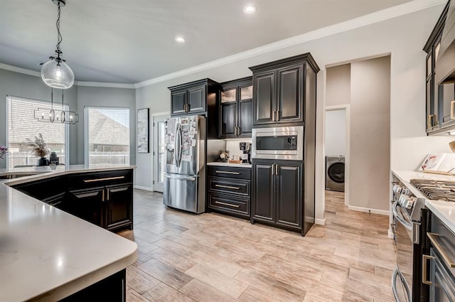 1219 N Adair Ct, Stillwater, OK 74075 - kitchen featuring washer / clothes dryer, ornamental molding, light countertops, hanging light fixtures, and stainless steel appliances