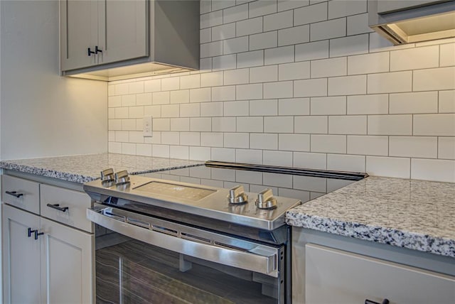 4980 12th Ave, Goldsby, OK 73093 - kitchen featuring tasteful backsplash, stainless steel electric range, gray cabinets, and light stone countertops