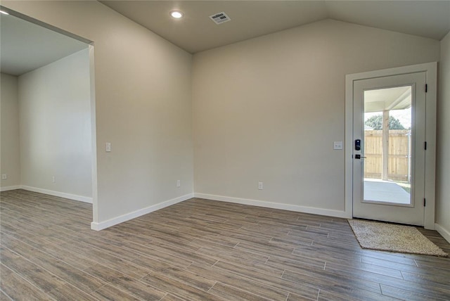 4980 12th Ave, Goldsby, OK 73093 - unfurnished room with wood finished floors, baseboards, recessed lighting, and vaulted ceiling