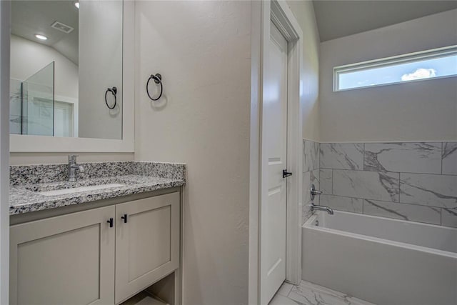 4980 12th Ave, Goldsby, OK 73093 - bathroom featuring marble finish flooring, vanity, and a bath