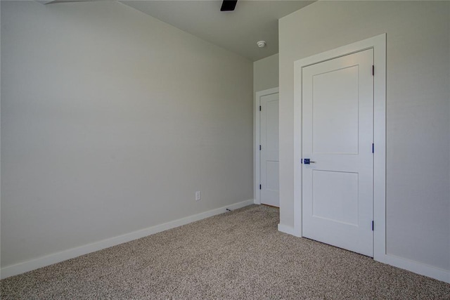 4980 12th Ave, Goldsby, OK 73093 - unfurnished bedroom featuring light colored carpet, baseboards, and a ceiling fan