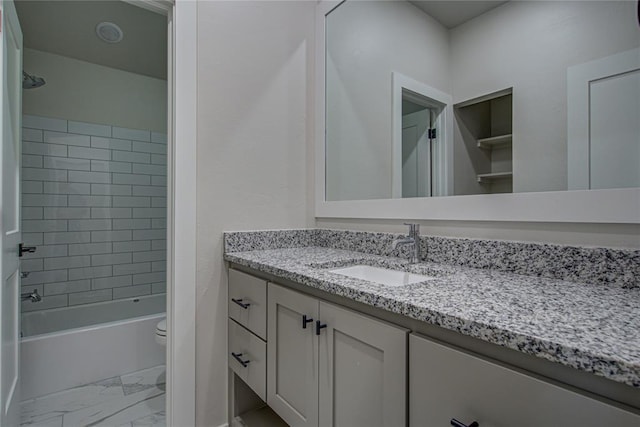 4980 12th Ave, Goldsby, OK 73093 - full bath featuring marble finish flooring, vanity, toilet, and bathtub / shower combination