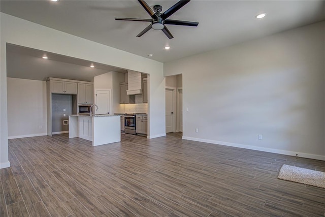 4980 12th Ave, Goldsby, OK 73093 - unfurnished living room featuring a sink, ceiling fan, baseboards, and recessed lighting