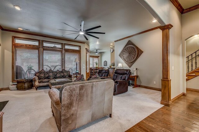 3615 S Scissortail Dr, Stillwater, OK 74074 - living area with baseboards, ornamental molding, ceiling fan, decorative columns, and arched walkways