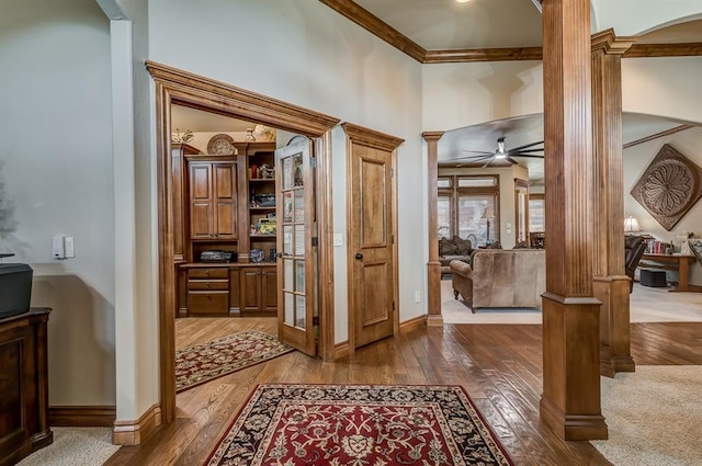 3615 S Scissortail Dr, Stillwater, OK 74074 - foyer with crown molding, wood-type flooring, ornate columns, and a ceiling fan
