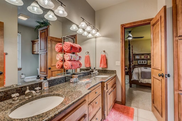 3615 S Scissortail Dr, Stillwater, OK 74074 - ensuite bathroom featuring a sink, toilet, double vanity, and tile patterned flooring