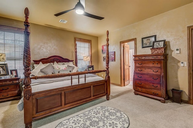 3615 S Scissortail Dr, Stillwater, OK 74074 - bedroom featuring visible vents, ceiling fan, multiple windows, and light colored carpet