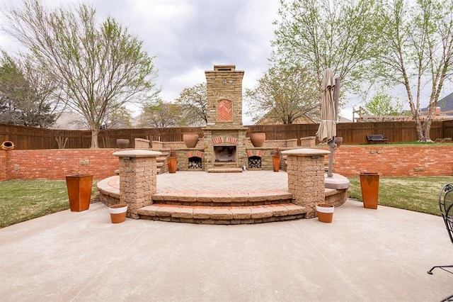 3615 S Scissortail Dr, Stillwater, OK 74074 - view of patio / terrace featuring fence and an outdoor stone fireplace