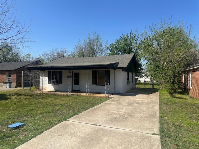 ranch-style house with driveway, a porch, a front yard, and roof with shingles