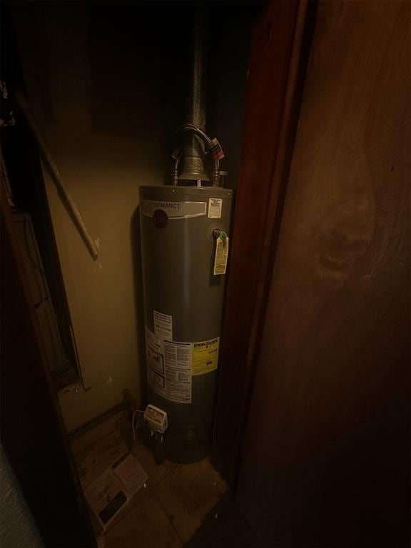 utility room featuring gas water heater