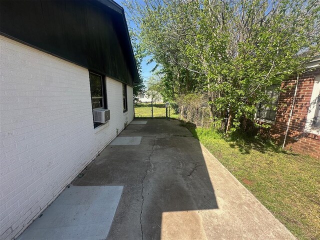 view of property exterior featuring brick siding and a yard