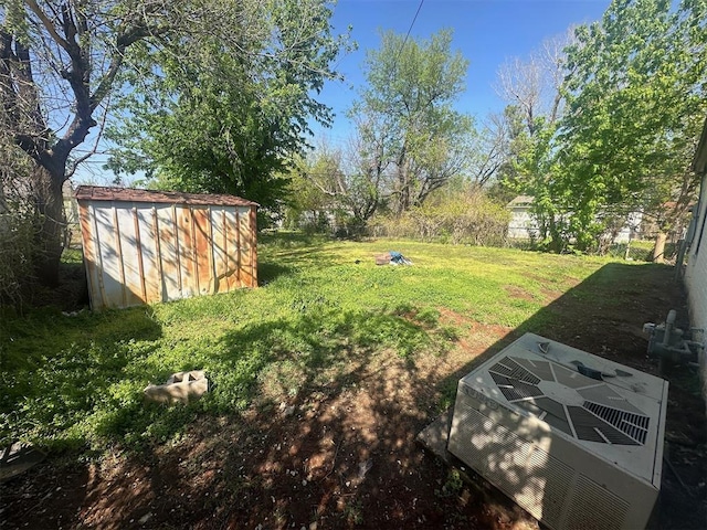 view of yard with an outdoor structure, a storage unit, and cooling unit