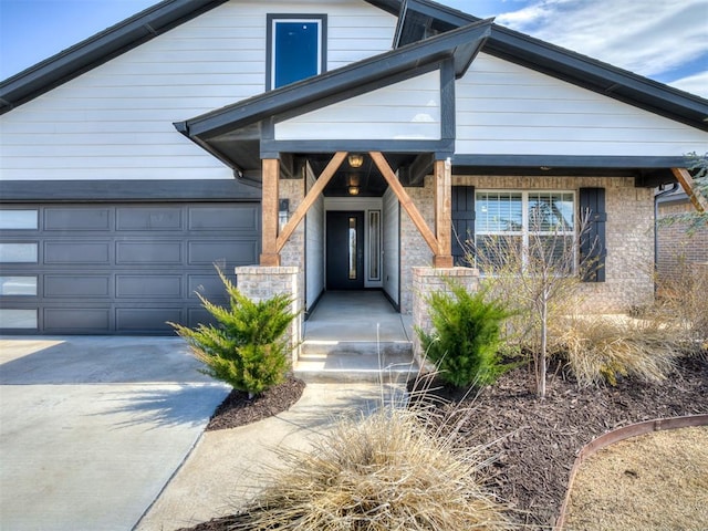 property entrance featuring a garage and driveway