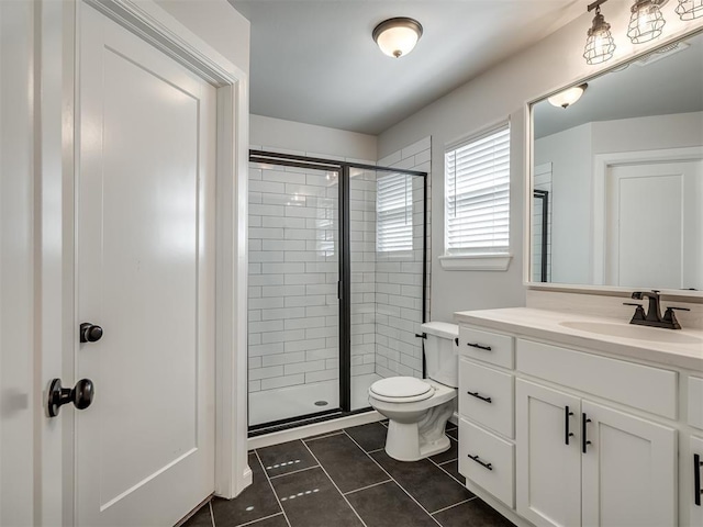 bathroom with toilet, tile patterned floors, vanity, and a stall shower