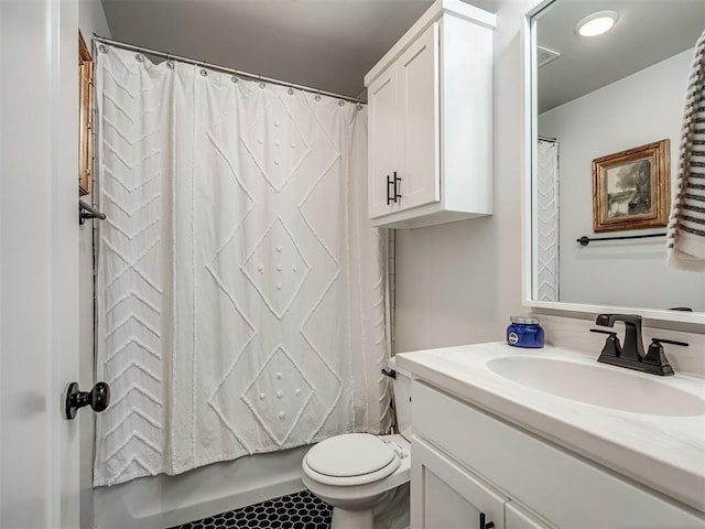 bathroom featuring toilet and vanity