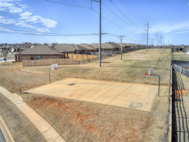 view of patio with a residential view, fence, and community basketball court