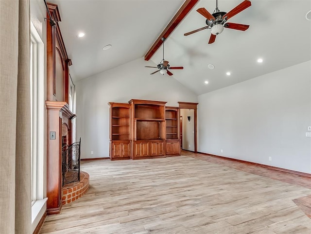 1217 Camelot Dr, Yukon, OK 73099 - unfurnished living room with high vaulted ceiling, a ceiling fan, light wood finished floors, a fireplace, and beam ceiling