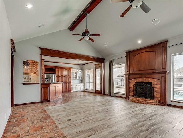 1217 Camelot Dr, Yukon, OK 73099 - unfurnished living room featuring lofted ceiling with beams, baseboards, recessed lighting, a ceiling fan, and a fireplace