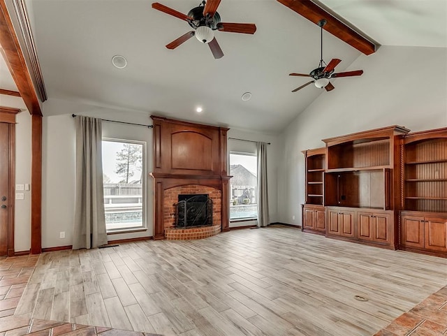 1217 Camelot Dr, Yukon, OK 73099 - unfurnished living room featuring beamed ceiling, light wood-style flooring, a ceiling fan, and high vaulted ceiling