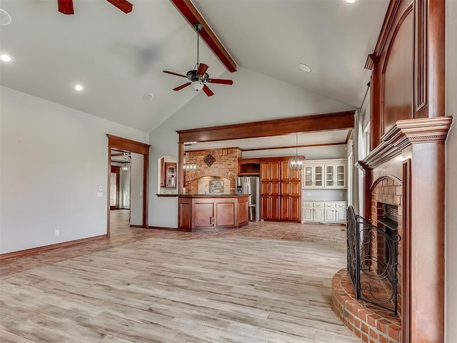1217 Camelot Dr, Yukon, OK 73099 - unfurnished living room featuring a fireplace, light wood-style flooring, beam ceiling, and ceiling fan with notable chandelier