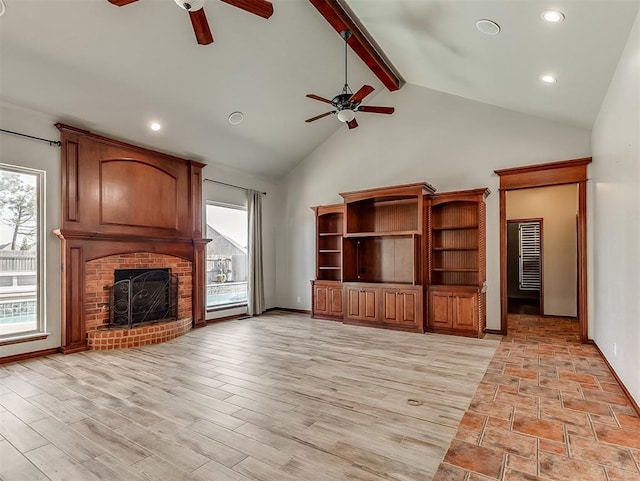1217 Camelot Dr, Yukon, OK 73099 - unfurnished living room featuring a fireplace, beam ceiling, ceiling fan, and high vaulted ceiling