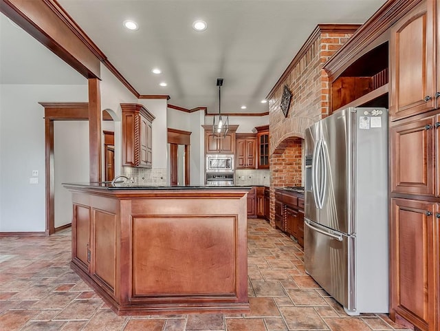 1217 Camelot Dr, Yukon, OK 73099 - kitchen featuring dark countertops, appliances with stainless steel finishes, decorative backsplash, and stone tile flooring