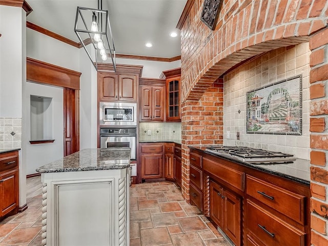 1217 Camelot Dr, Yukon, OK 73099 - kitchen with crown molding, appliances with stainless steel finishes, dark stone counters, and decorative backsplash