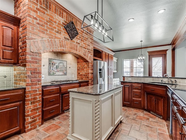 1217 Camelot Dr, Yukon, OK 73099 - kitchen with a sink, decorative backsplash, an inviting chandelier, stainless steel appliances, and stone finish flooring