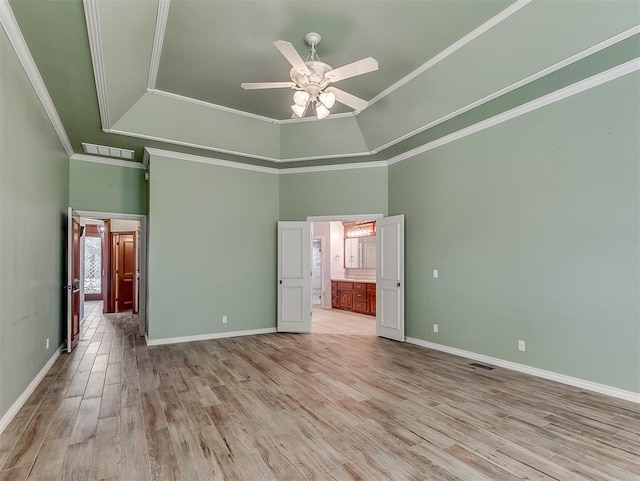 1217 Camelot Dr, Yukon, OK 73099 - unfurnished bedroom featuring visible vents, baseboards, a towering ceiling, and light wood-type flooring