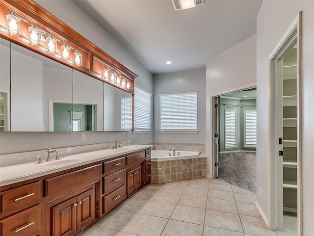 1217 Camelot Dr, Yukon, OK 73099 - full bathroom featuring tile patterned flooring, visible vents, a garden tub, and a sink