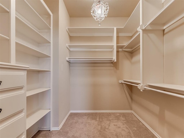 1217 Camelot Dr, Yukon, OK 73099 - walk in closet with an inviting chandelier and carpet