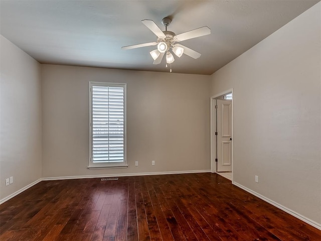 1217 Camelot Dr, Yukon, OK 73099 - unfurnished room featuring dark wood-type flooring, a wealth of natural light, baseboards, and ceiling fan