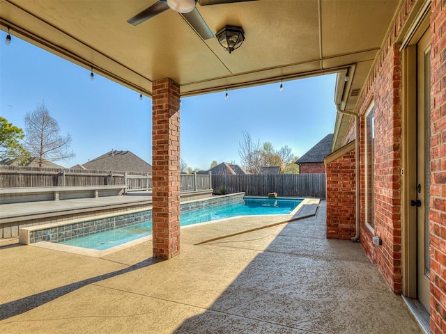 1217 Camelot Dr, Yukon, OK 73099 - view of swimming pool with a patio area, a fenced in pool, a fenced backyard, and a ceiling fan