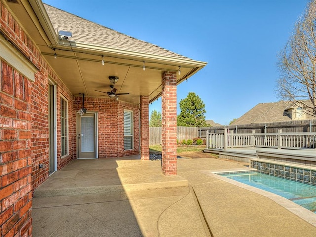 1217 Camelot Dr, Yukon, OK 73099 - view of patio / terrace featuring ceiling fan, a fenced backyard, and a fenced in pool