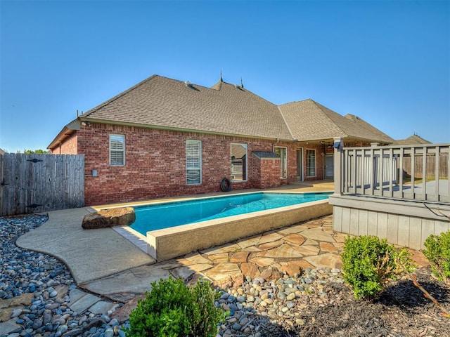 1217 Camelot Dr, Yukon, OK 73099 - view of swimming pool featuring fence, a patio, a deck, and a fenced in pool